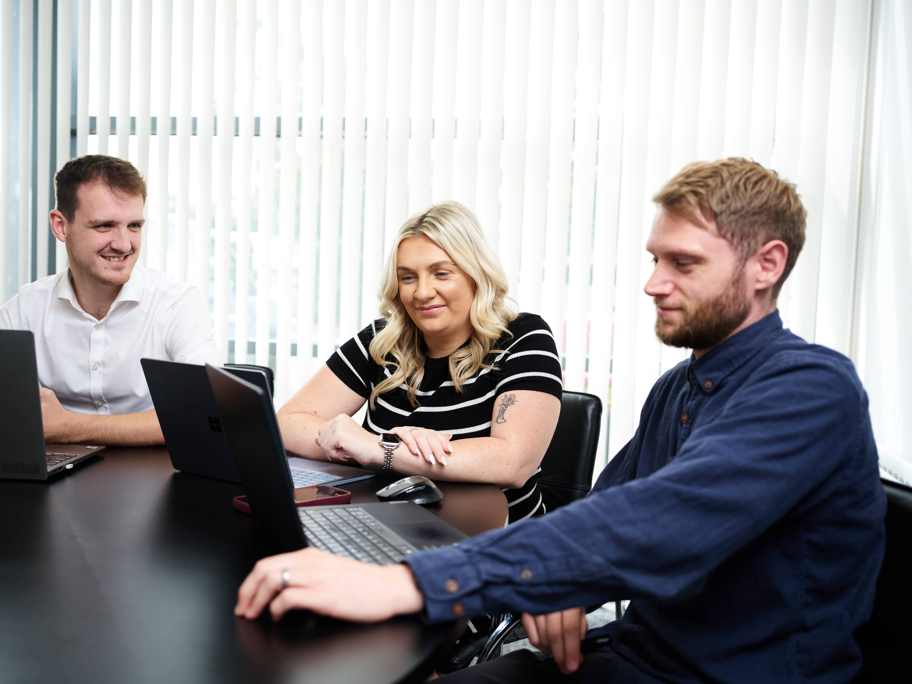 OKTO team collaborating across laptops and systems in OKTOLabs